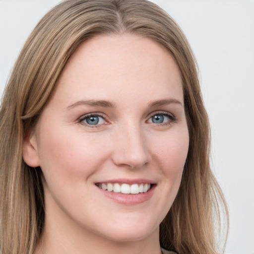 Joyful white young-adult female with long  brown hair and blue eyes