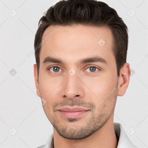 Joyful white young-adult male with short  brown hair and brown eyes