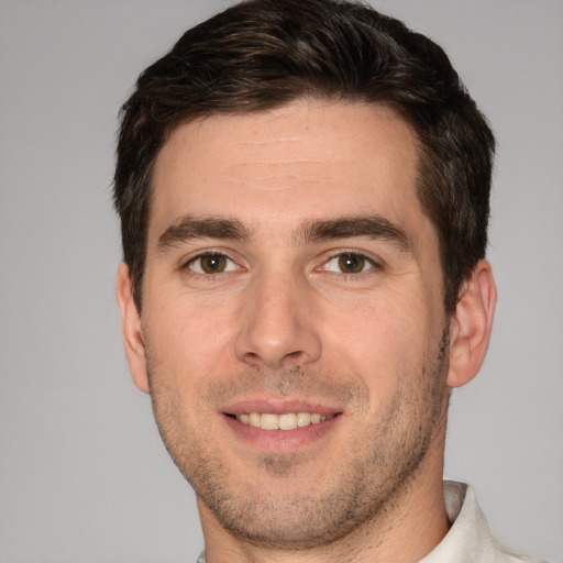 Joyful white young-adult male with short  brown hair and brown eyes