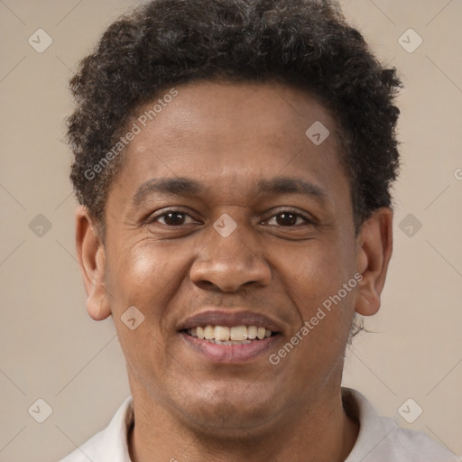 Joyful latino adult male with short  brown hair and brown eyes