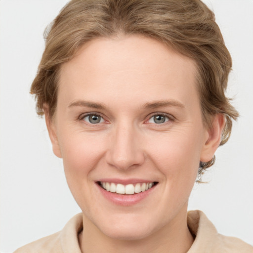 Joyful white young-adult female with short  brown hair and grey eyes