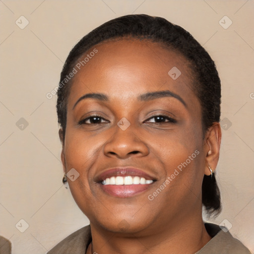 Joyful black young-adult female with short  black hair and brown eyes