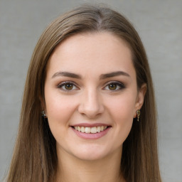 Joyful white young-adult female with long  brown hair and green eyes