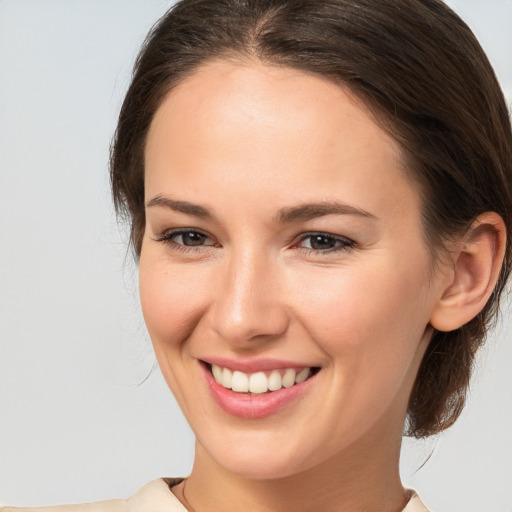 Joyful white young-adult female with medium  brown hair and brown eyes