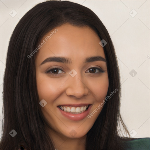 Joyful latino young-adult female with long  brown hair and brown eyes