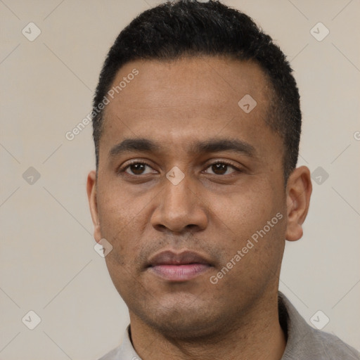 Neutral latino young-adult male with short  black hair and brown eyes