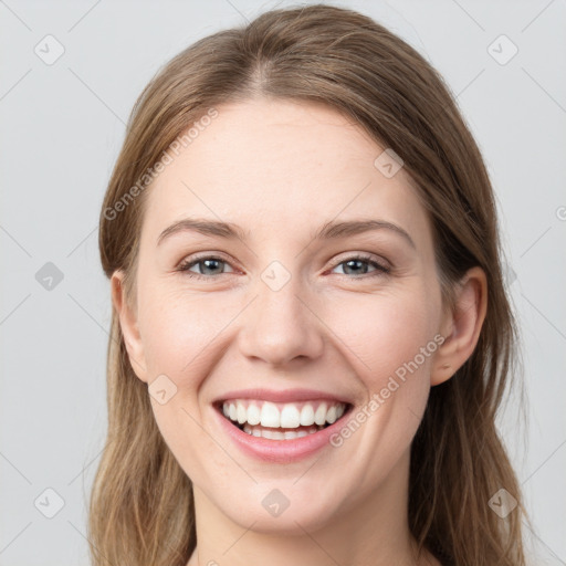 Joyful white young-adult female with long  brown hair and grey eyes