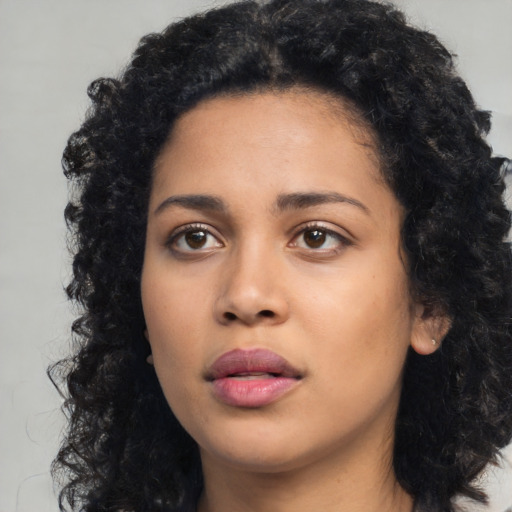 Joyful latino young-adult female with medium  black hair and brown eyes