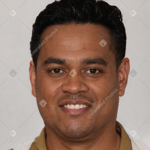 Joyful latino young-adult male with short  black hair and brown eyes