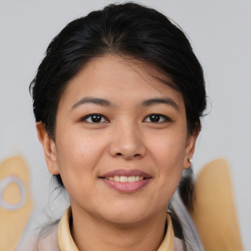 Joyful asian young-adult female with medium  brown hair and brown eyes
