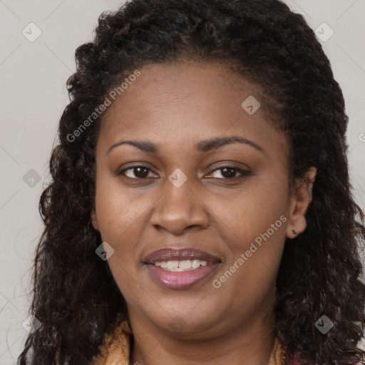 Joyful black young-adult female with long  brown hair and brown eyes