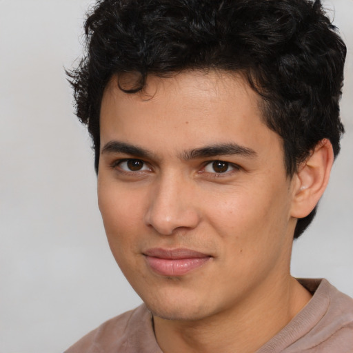 Joyful latino young-adult male with short  brown hair and brown eyes