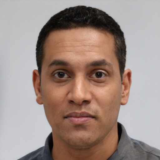 Neutral latino adult male with short  black hair and brown eyes