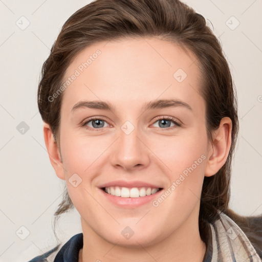 Joyful white young-adult female with long  brown hair and blue eyes