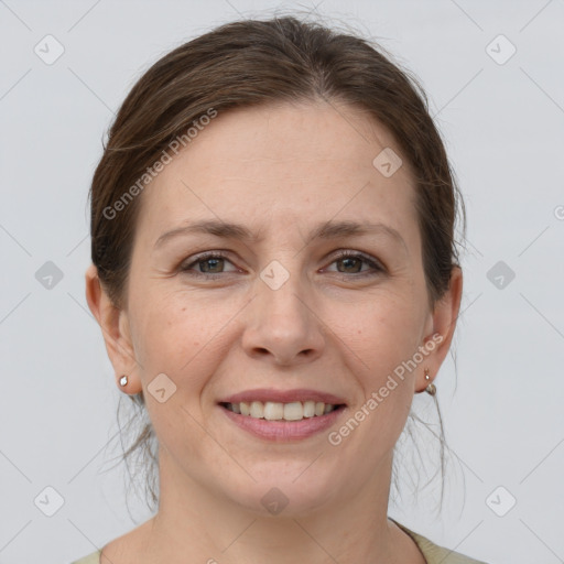 Joyful white adult female with medium  brown hair and grey eyes