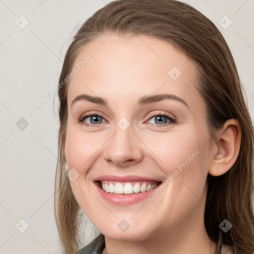 Joyful white young-adult female with long  brown hair and grey eyes