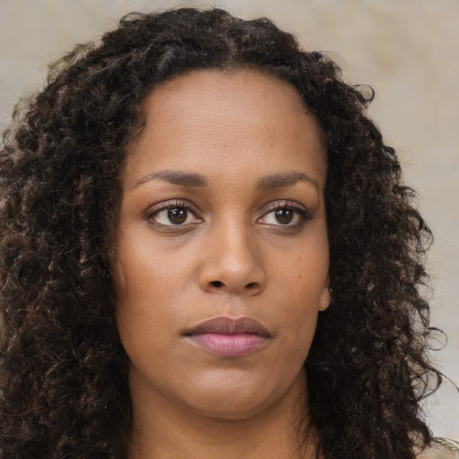 Neutral black young-adult female with long  brown hair and brown eyes