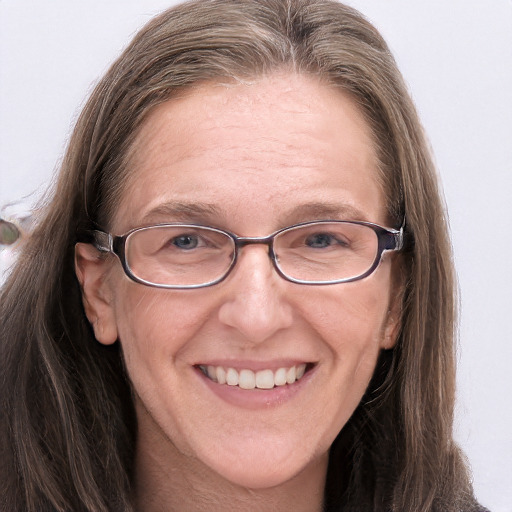 Joyful white adult female with long  brown hair and grey eyes