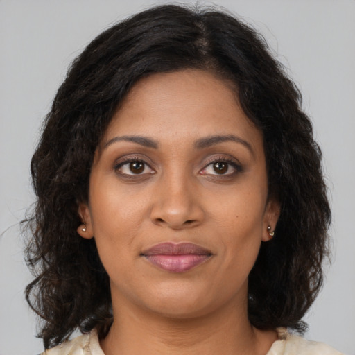 Joyful black young-adult female with medium  brown hair and brown eyes