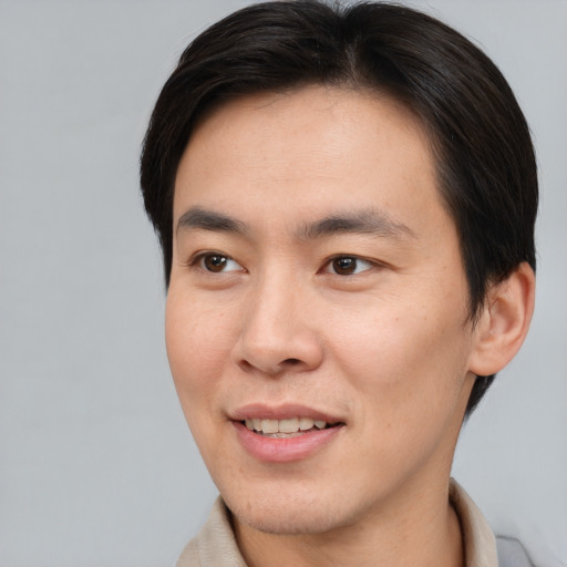Joyful asian young-adult male with short  brown hair and brown eyes