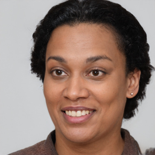 Joyful latino adult female with short  brown hair and brown eyes