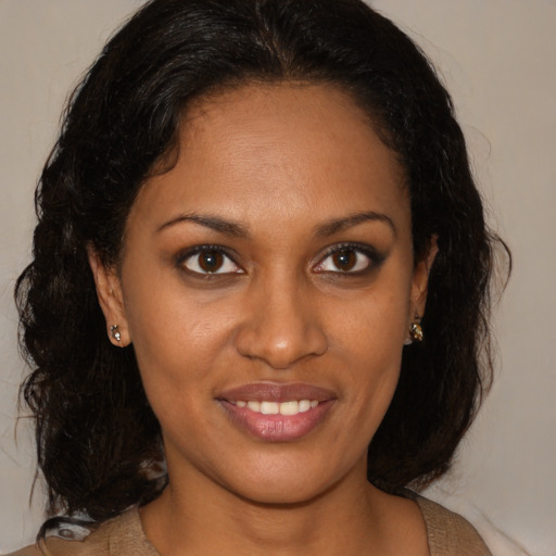 Joyful black young-adult female with medium  brown hair and brown eyes