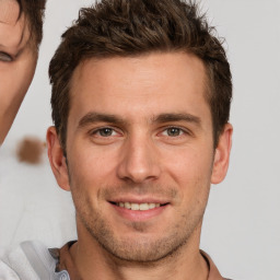 Joyful white young-adult male with short  brown hair and brown eyes