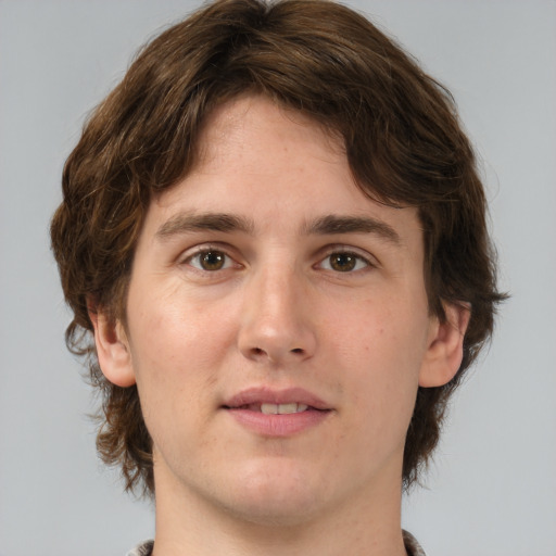 Joyful white young-adult male with medium  brown hair and brown eyes