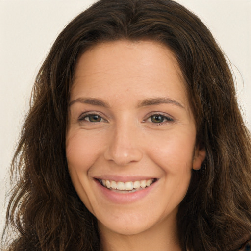 Joyful white young-adult female with long  brown hair and brown eyes