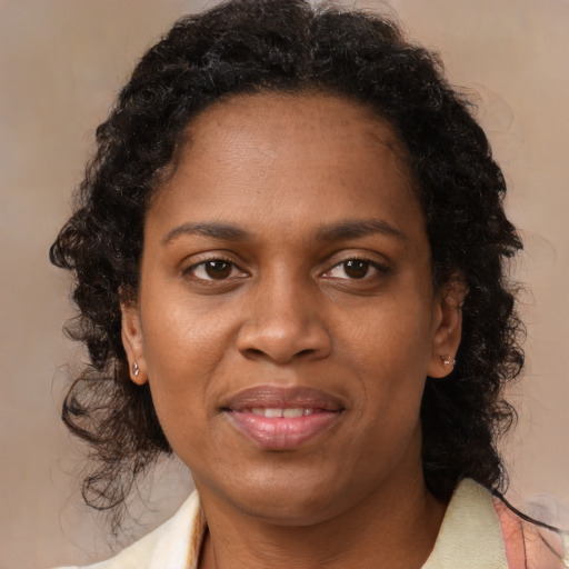 Joyful black adult female with medium  brown hair and brown eyes