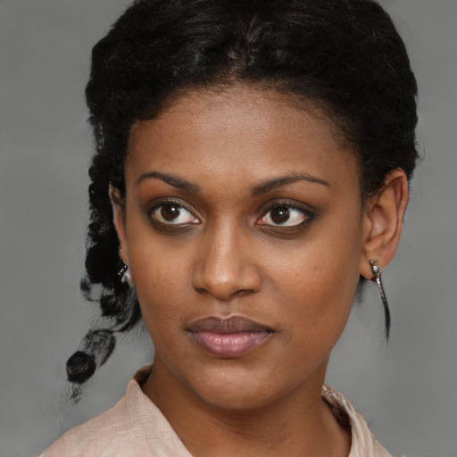 Neutral black young-adult female with medium  brown hair and brown eyes