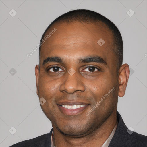 Joyful black young-adult male with short  black hair and brown eyes