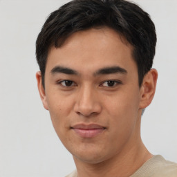 Joyful asian young-adult male with short  black hair and brown eyes