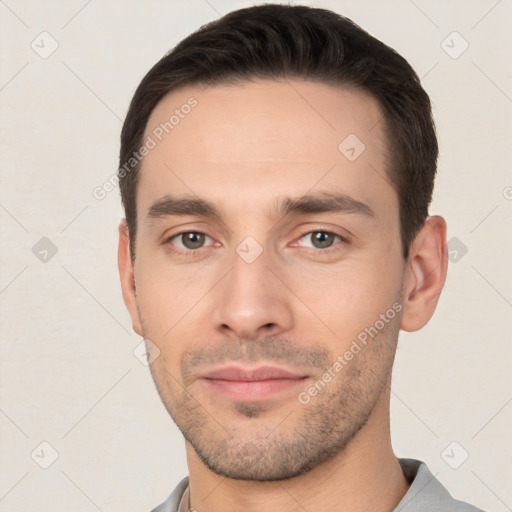 Joyful white young-adult male with short  black hair and brown eyes