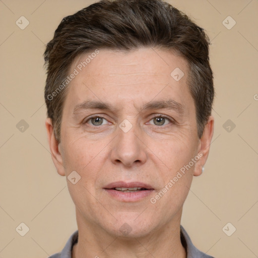 Joyful white adult male with short  brown hair and grey eyes