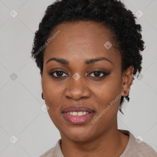 Joyful black young-adult female with short  black hair and brown eyes