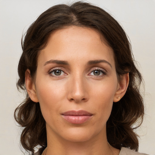 Joyful white young-adult female with medium  brown hair and grey eyes