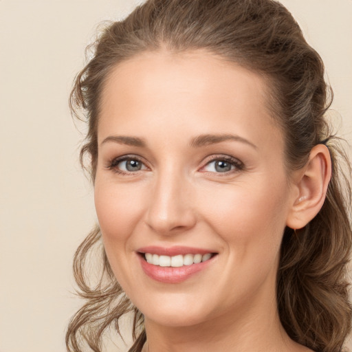 Joyful white young-adult female with long  brown hair and grey eyes