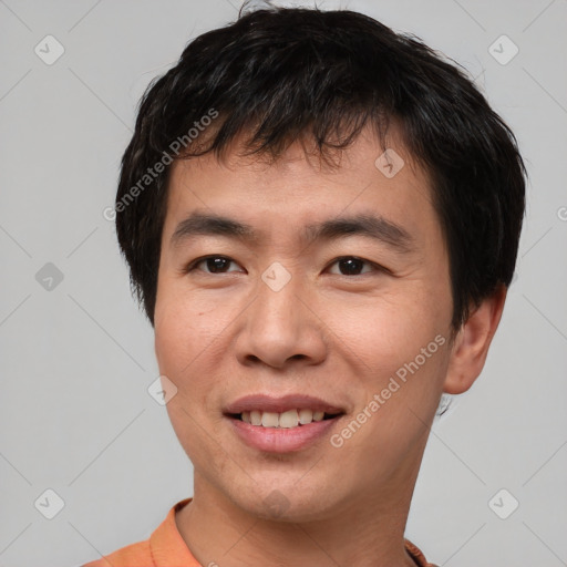 Joyful asian young-adult male with short  brown hair and brown eyes