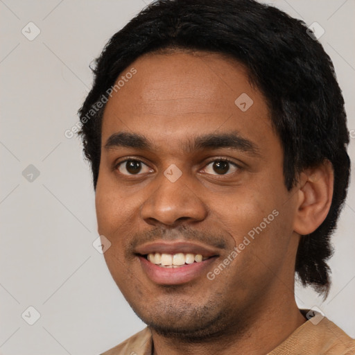 Joyful black young-adult male with short  black hair and brown eyes