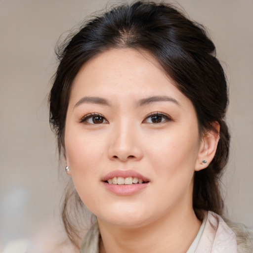 Joyful asian young-adult female with medium  brown hair and brown eyes