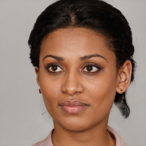 Joyful black young-adult female with short  brown hair and brown eyes