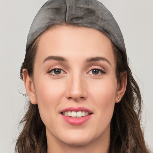 Joyful white young-adult female with long  brown hair and grey eyes