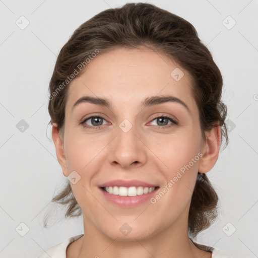 Joyful white young-adult female with medium  brown hair and grey eyes