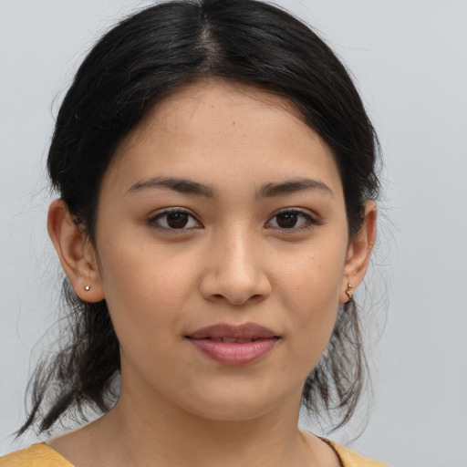 Joyful latino young-adult female with medium  brown hair and brown eyes