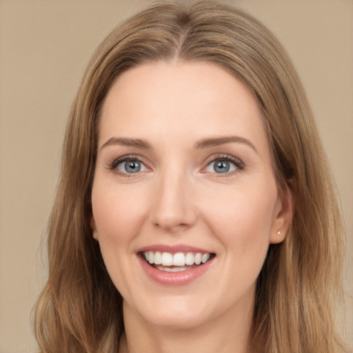 Joyful white young-adult female with long  brown hair and grey eyes