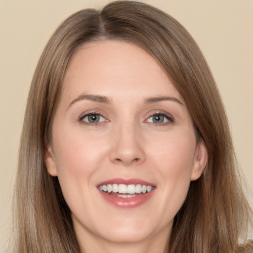 Joyful white young-adult female with long  brown hair and grey eyes