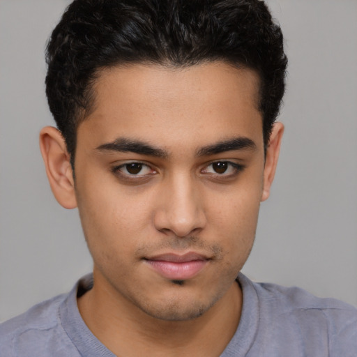 Joyful latino young-adult male with short  brown hair and brown eyes