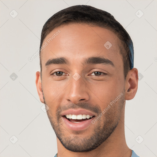 Joyful white young-adult male with short  black hair and brown eyes