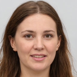 Joyful white adult female with long  brown hair and brown eyes